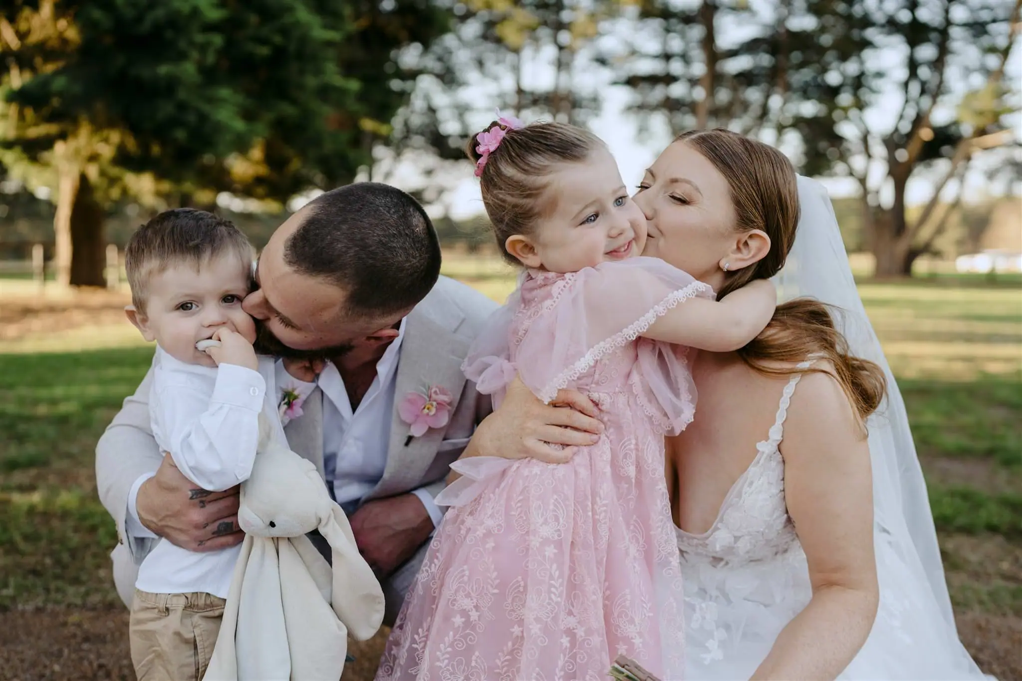 Bride and groom sharing a moment with their children