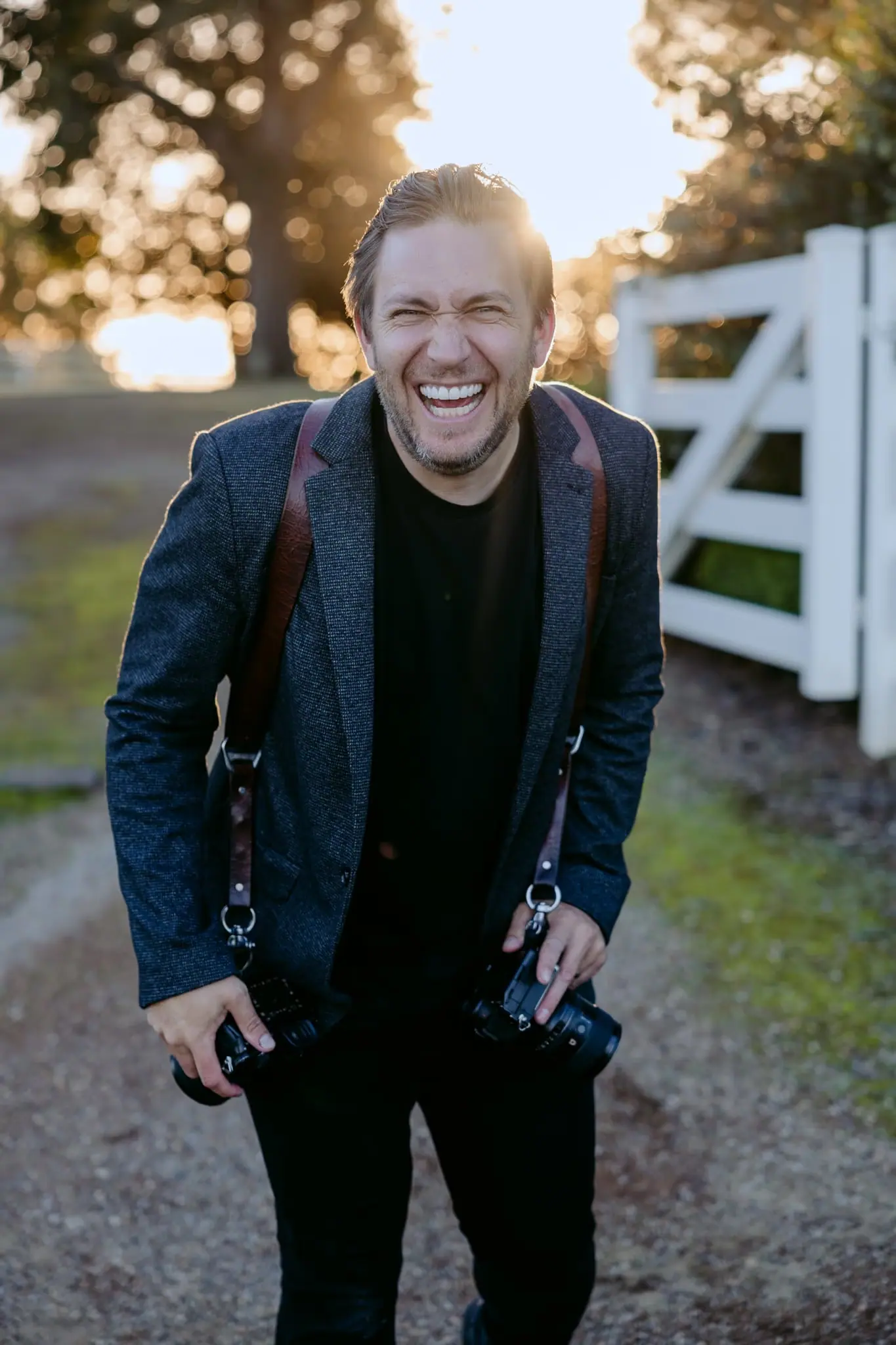 Michael Briggs, wedding photographer, laughing with two cameras in the Yarra Valley